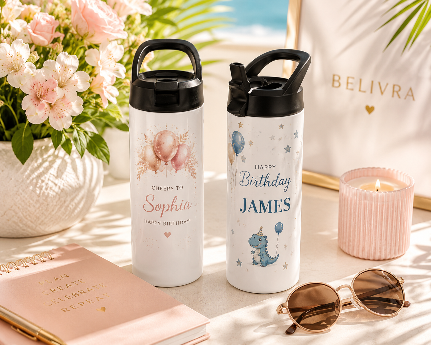 Two personalized insulated tumblers with celebration designs displayed on a modern tabletop with fresh flowers, notebook, and sunglasses in bright Florida sunlight, styled as a premium boutique gift.