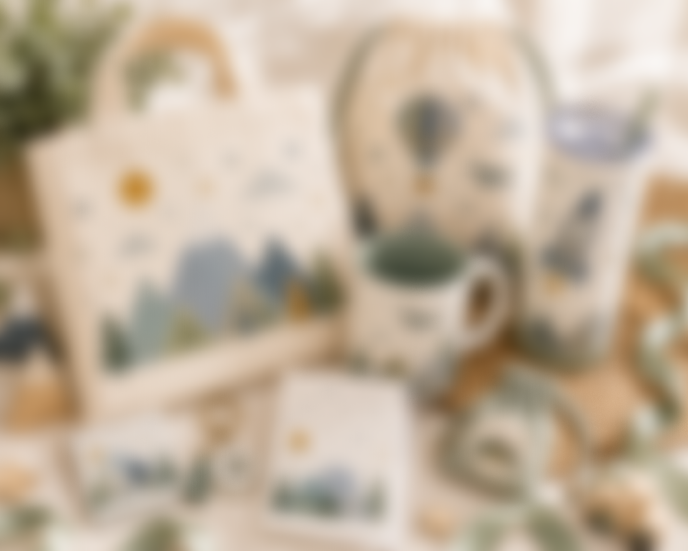 Blurred image of a collection of decorative ceramic items on a table, including a teapot, cups, and other kitchenware with a light-colored floral or abstract pattern.