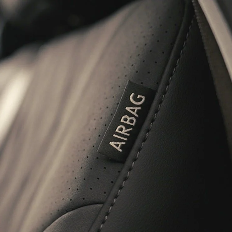 Close-up of a car seat with a label marked 'AIRBAG' indicating the presence of an airbag feature.