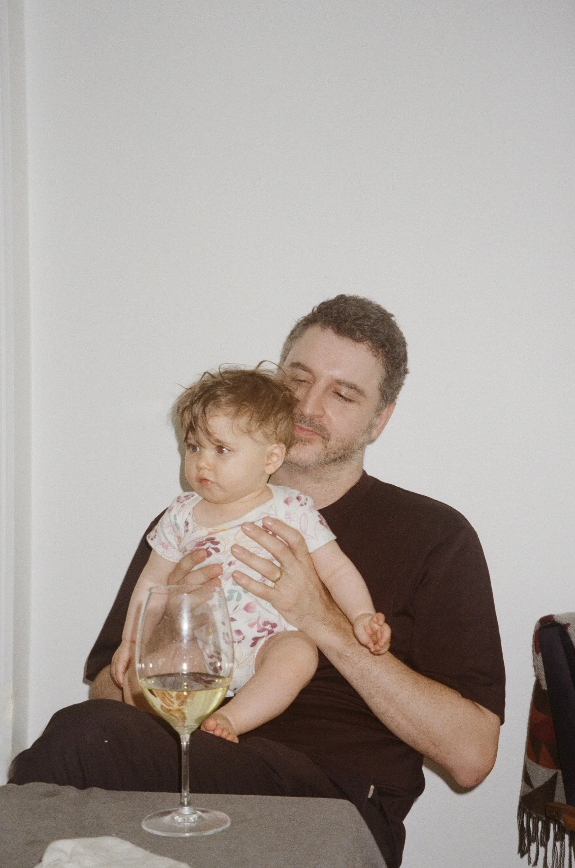 Father and baby with a glass of wine