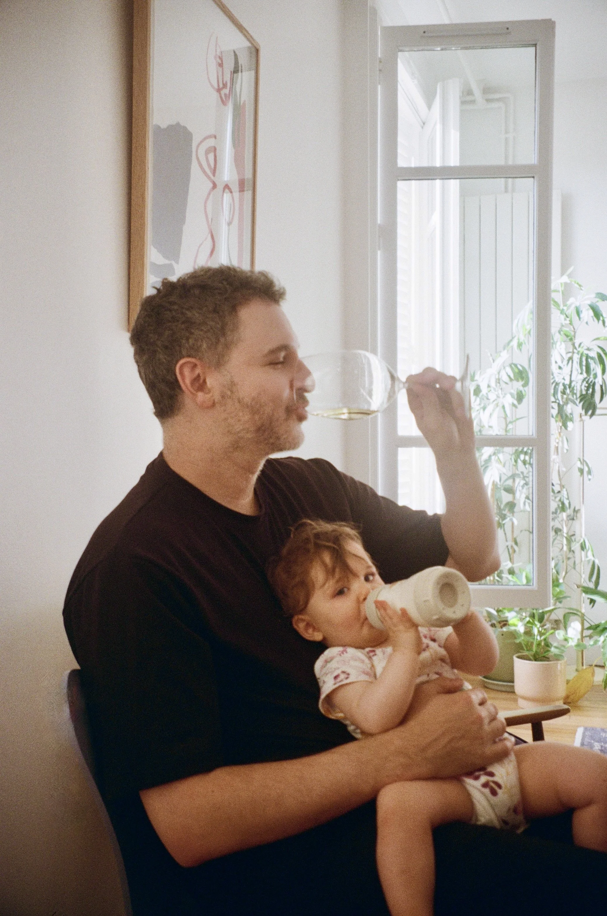 Father and baby with a glass of wine