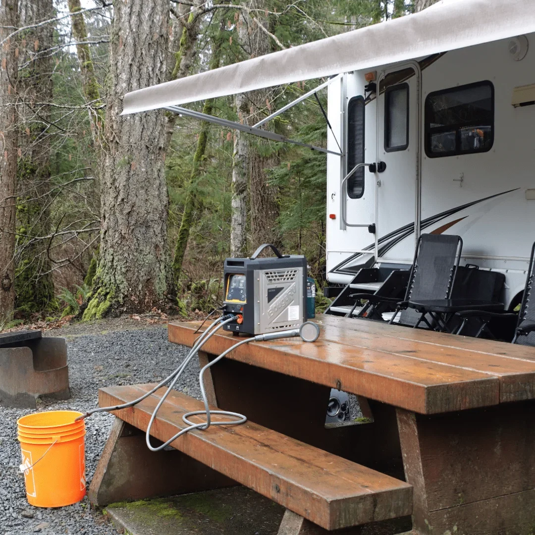 BougeRV propane water heater set up on a picnic table by an RV