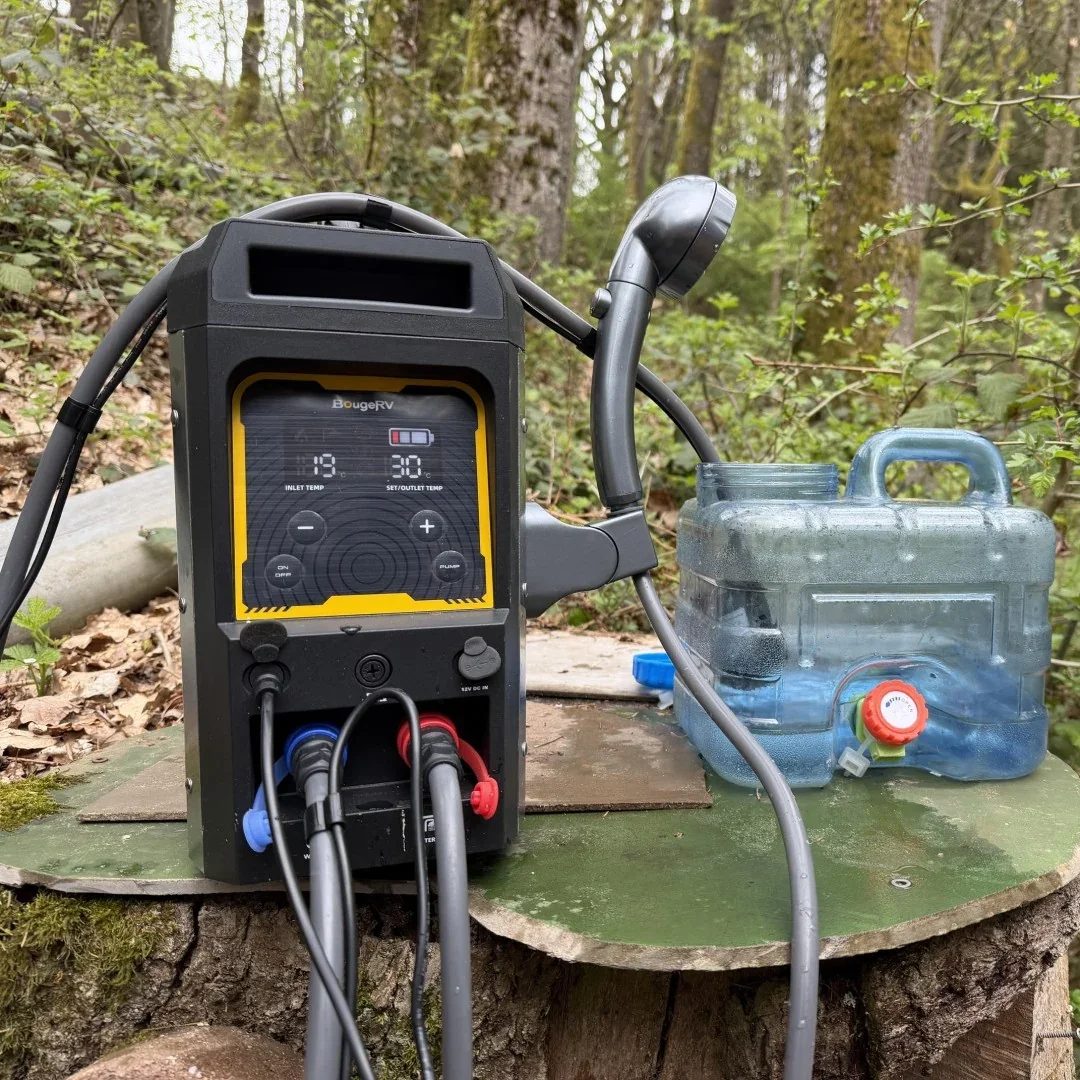 BougeRV propane water heater with hose reel and water container at a campsite