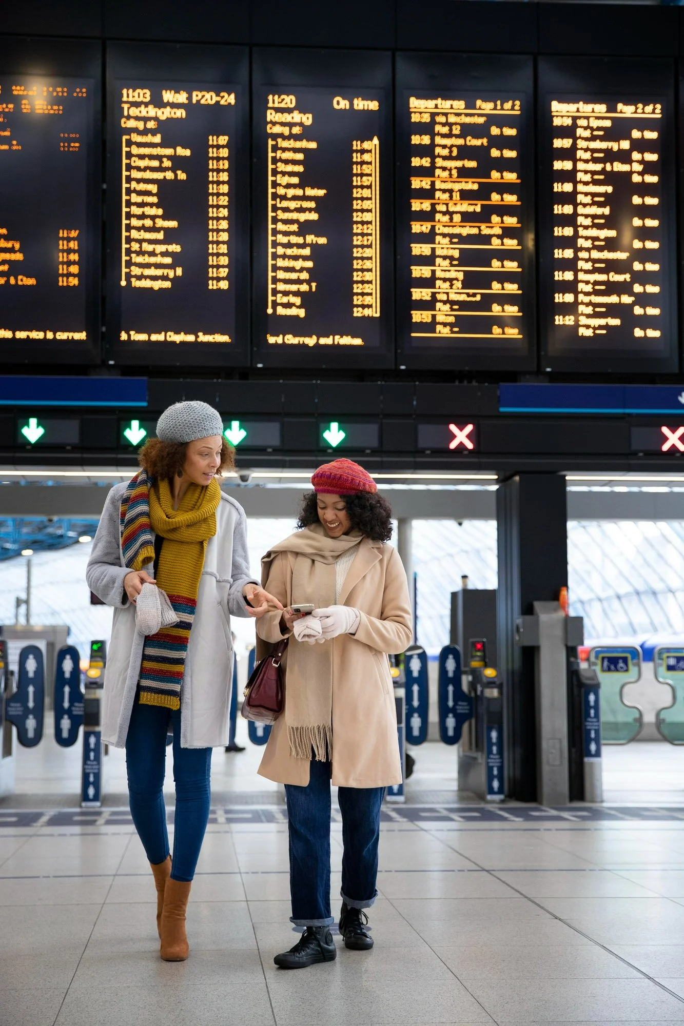 Travelers Using Mobile Devices in a Busy Airport Terminal