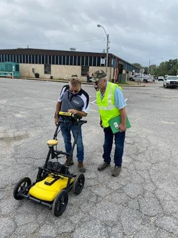 Close-up of a ground penetrating radar cart with two technicians during a locator and GPR demonstration in Memphis, Tennessee.