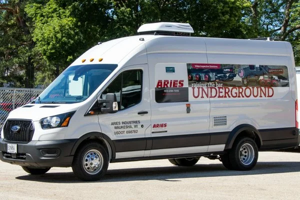 Aries Industries sewer pipeline inspection van parked outdoors, branded with graphics reading "Underground."