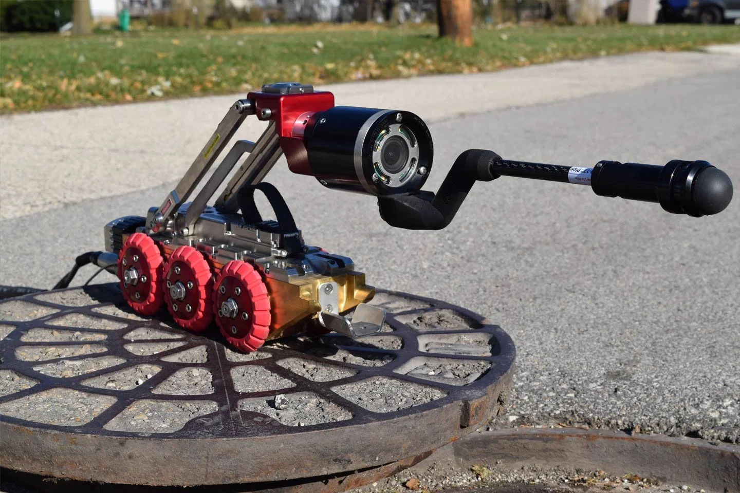 Aries Pathfinder mainline crawler fitted with a laser measurement attachment on a manhole cover.