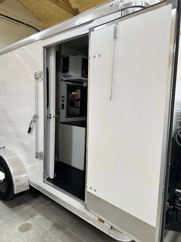 Open side entrance door of an Aries pipeline television inspection trailer.