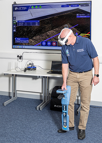 Instructor using the Utility Locator Training Simulator (UTTO) to demonstrate hands-on underground locating training.