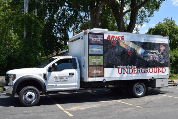 Aries Industries sewer inspection truck parked outdoors, branded with graphics reading "Underground."