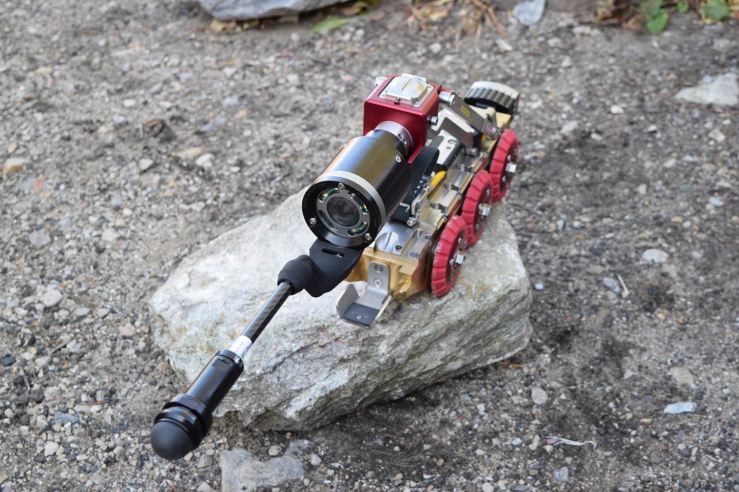 Close-up of the Aries Pathfinder mainline sewer inspection crawler resting on gravel.