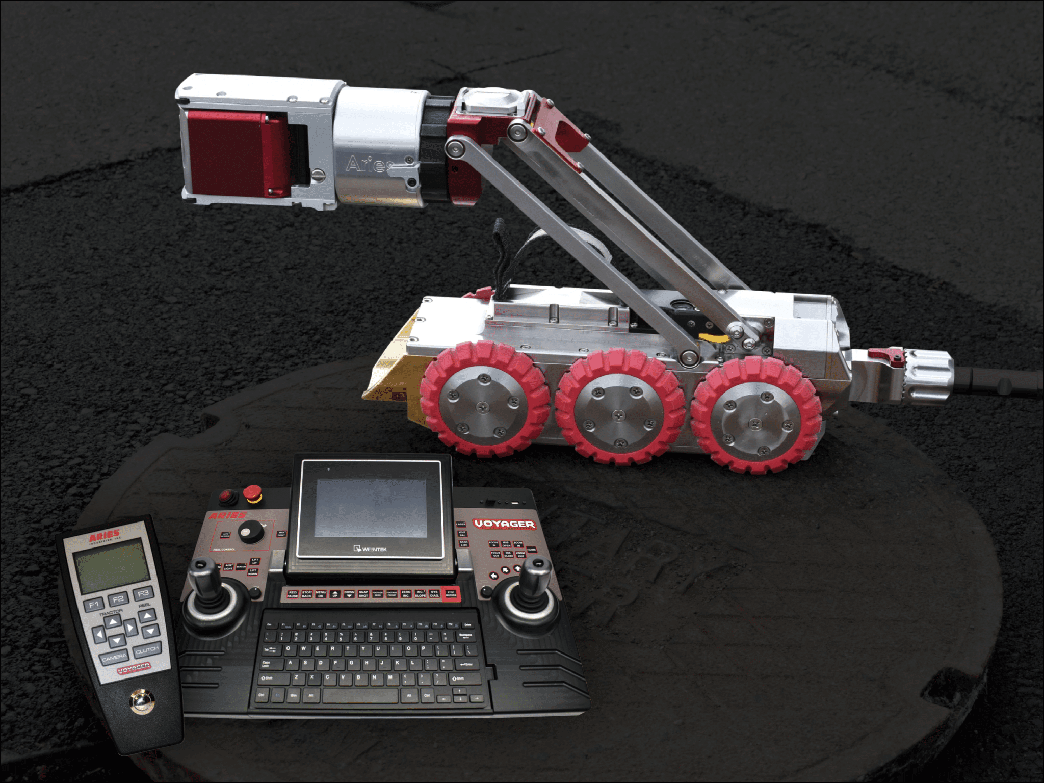 Aries Voyager HD mainline inspection crawler shown with its handheld controller and reel-mounted pendant.