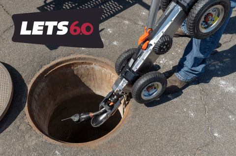 Aries LETS Sidewinder lateral inspection system crawler positioned on a manhole cover.