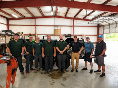 C&S Solutions team standing together in a warehouse for a group photo.