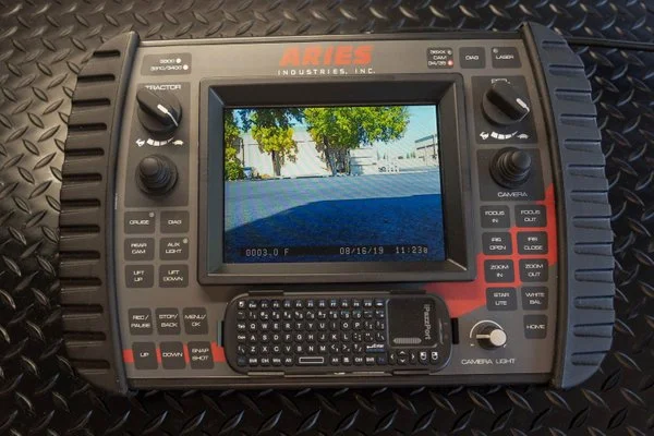 Aries Industries control console with monitor and keyboard, used to operate a mainline inspection crawler.