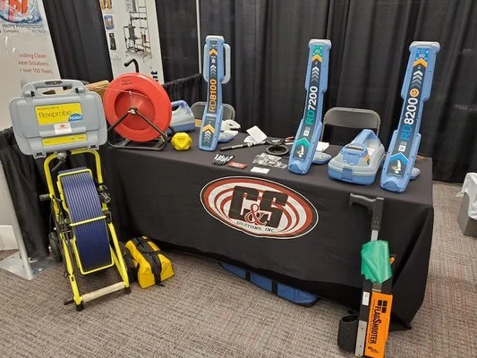 C&S Solutions product display booth featuring locating equipment and a hose reel at the Alliance of Indiana Rural Water Spring Conference.