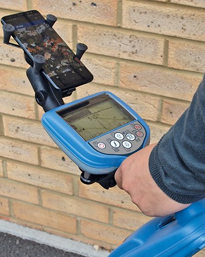 Close-up of a Radiodetection locator receiver display showing depth and signal readings during use.