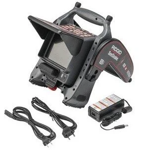 RIDGID CS6x Versa digital reporting monitor with Wi-Fi shown with pivoting sunshade frame, cables, and battery charger.