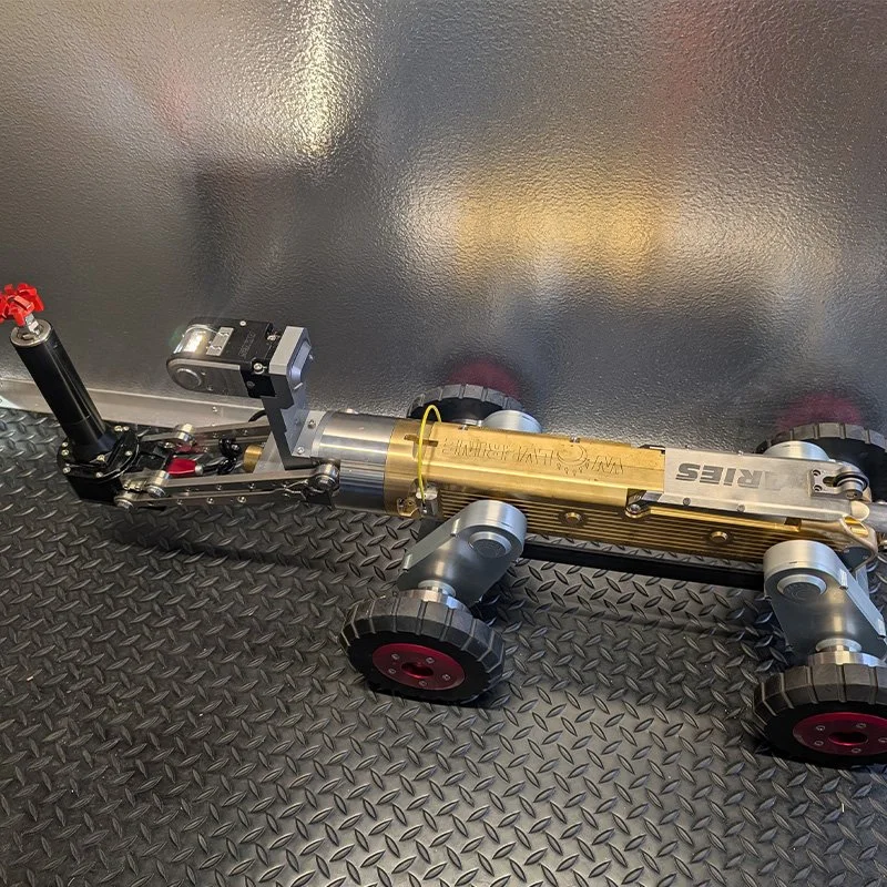 Close-up of the Aries Wolverine robotic electric cutting crawler shown on a diamond plate surface.