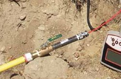 Jameson lateral gas line tracer wire connection installed underground near a locating transmitter.
