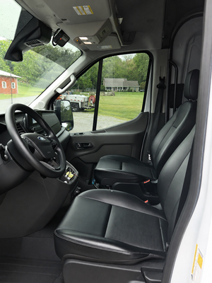 Driver's cab interior of the sewer inspection demo van showing the front seats and steering wheel.