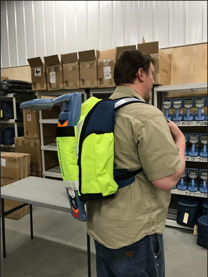 Technician wearing a Radiodetection backpack for carrying utility locating equipment.
