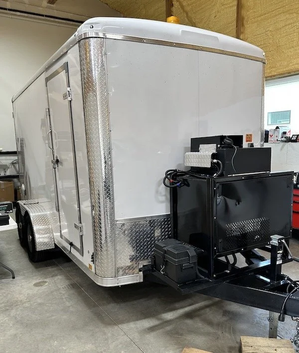 Rear exterior view of an Aries pipeline inspection trailer with external equipment mounted at the back.