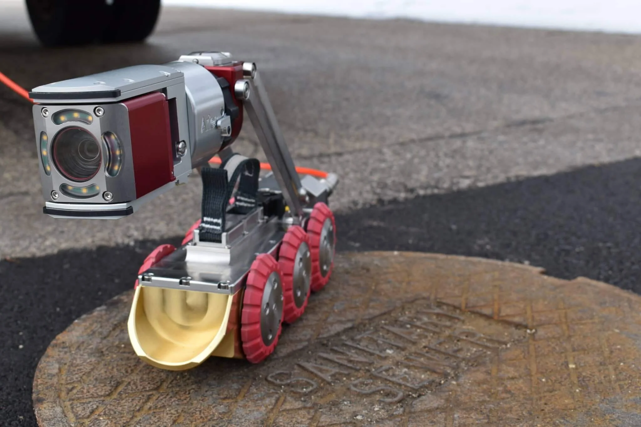 Aries Voyager HD mainline inspection crawler positioned on a manhole cover.