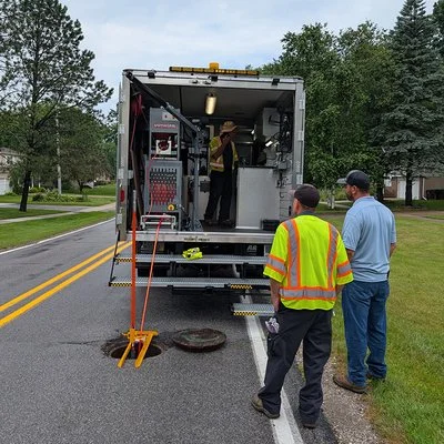 Aries Wolverine cutter truck demonstration at a manhole access point in Michigan.