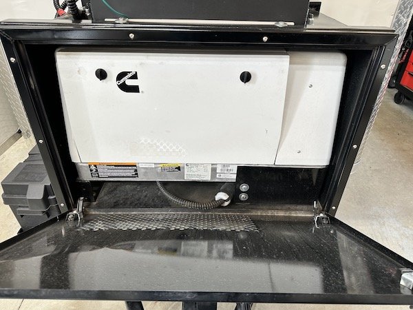 Cummins generator access panel on the underside of an Aries pipeline inspection trailer.