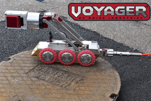 Aries Voyager HD mainline inspection crawler with WiperCam positioned on a manhole cover.
