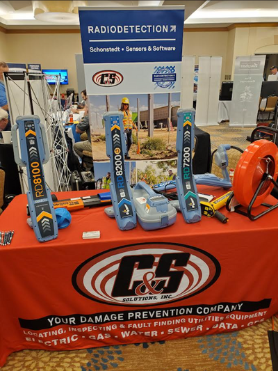 C&S Solutions equipment display booth featuring locators and a hose reel at the 2024 OHWA Annual Conference in Dublin, Ohio.