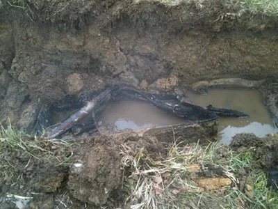 Close-up of exposed soil and debris at an excavation site.