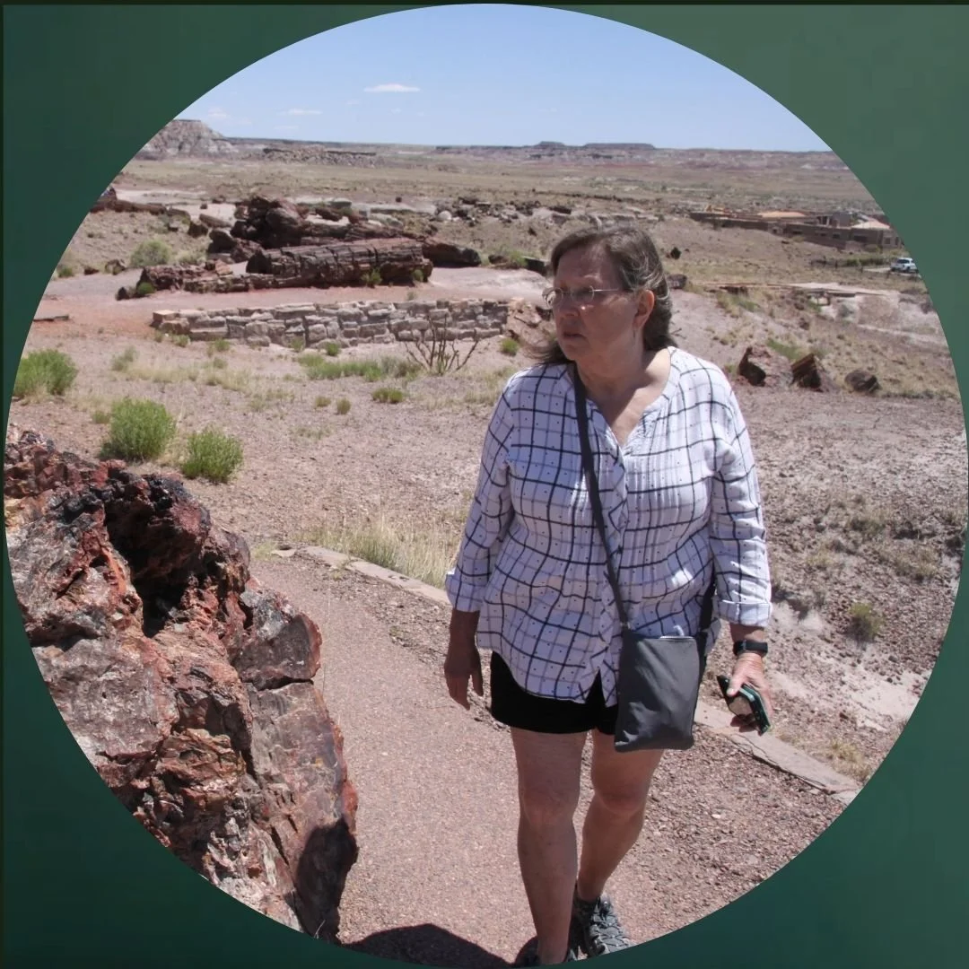 Bodyshot of woman with long gray hair walking through the petrified forest
