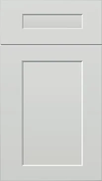 Close-up of a white kitchen cabinet door with a rectangular handle slot.