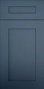 A close-up of a blue cabinet door with a rectangular label holder at the top.