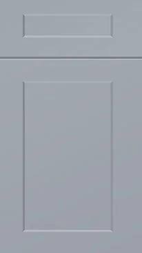 A close-up view of a light gray kitchen cabinet door with a rectangular inset panel.