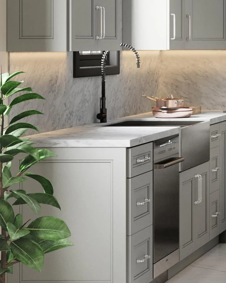 A modern kitchen countertop with gray cabinets, a marble surface, a built-in dishwasher, a black faucet, copper pots, and a green houseplant to the side.