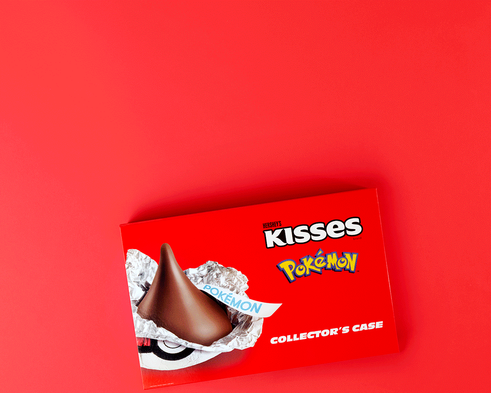 A Hershey's Kisses chocolate box themed with Pokémon branding, featuring a chocolate Hershey's Kiss with a Pokémon label, on a red background.