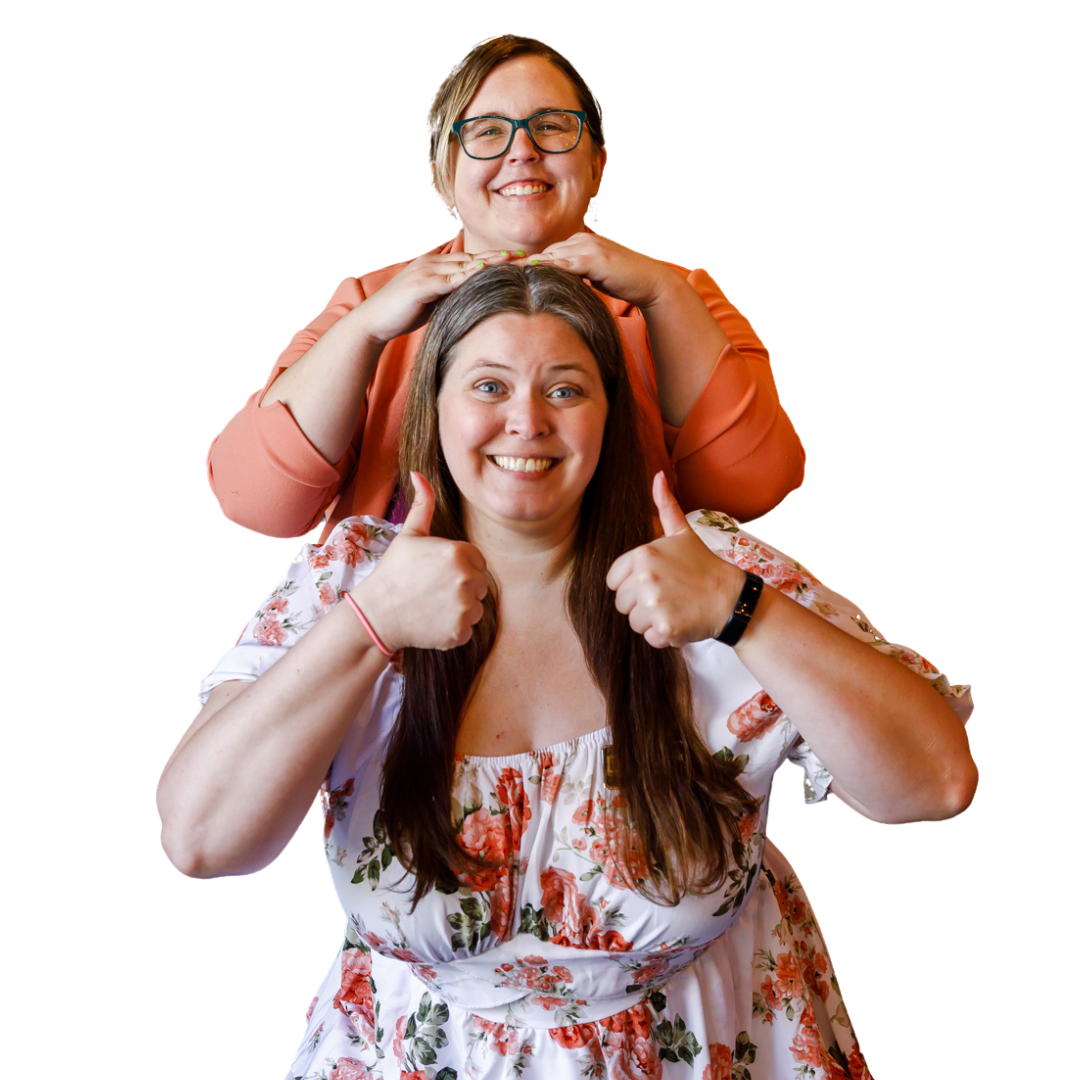 Two women smiling, one giving a thumbs-up and the other making a peace sign, standing in a stacked formation, isolated on a white background.