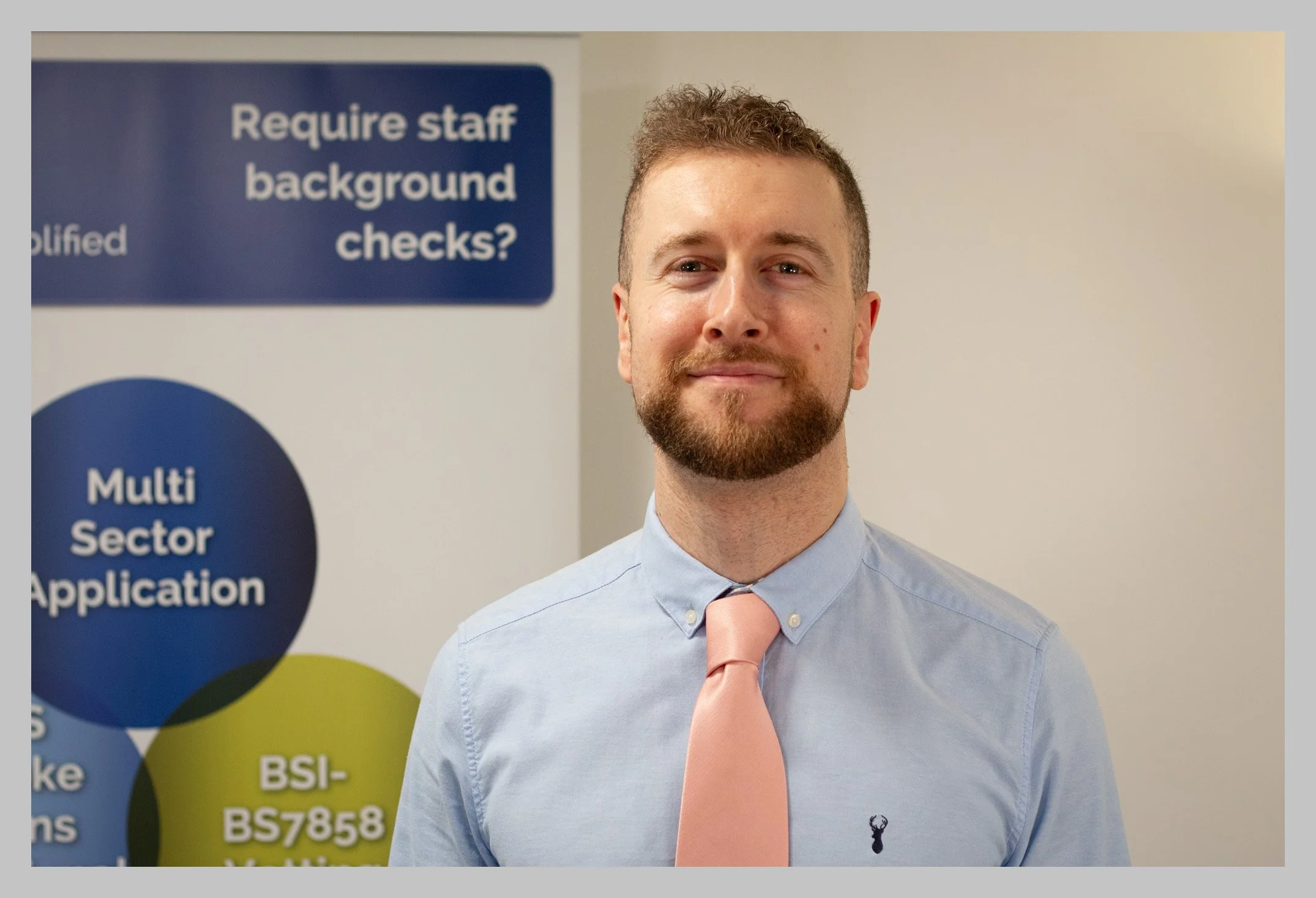 Mike beside poster with border.jpg