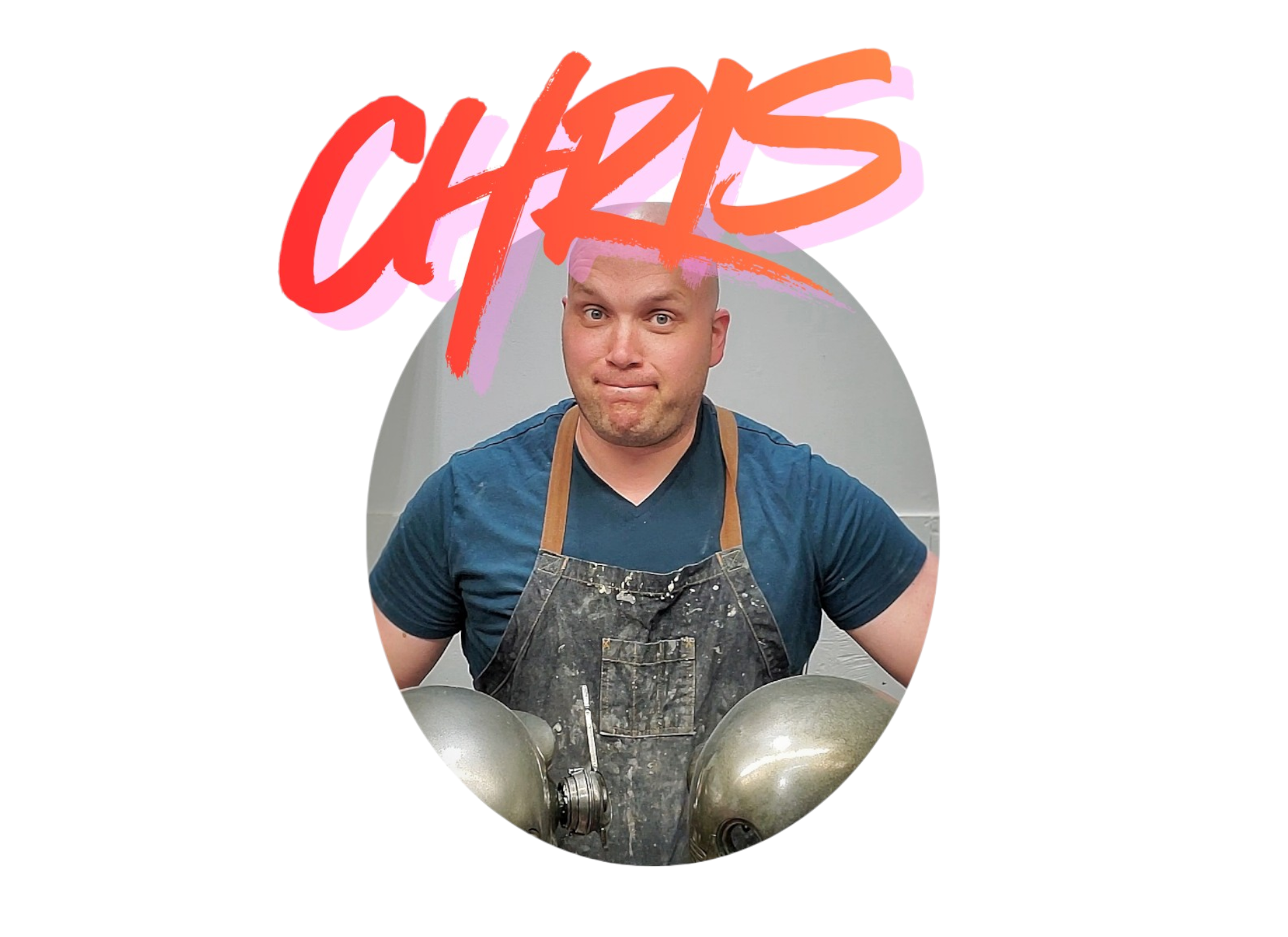 A man with a shaved head wearing a blue shirt and a black apron, standing behind large metal pots, in what appears to be a kitchen or cooking area.