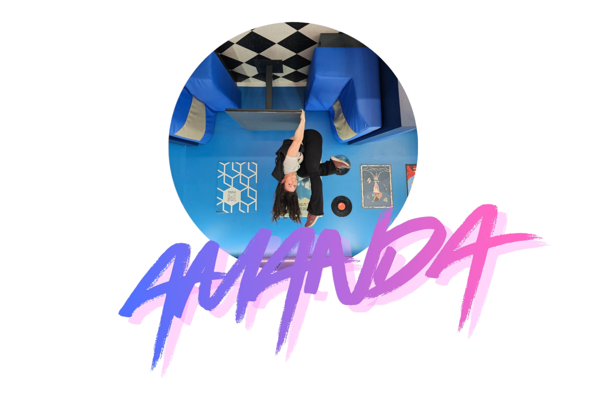A woman sitting on a blue couch with a vinyl record and a framed picture nearby, in a room with blue walls and black and white checkered flooring.