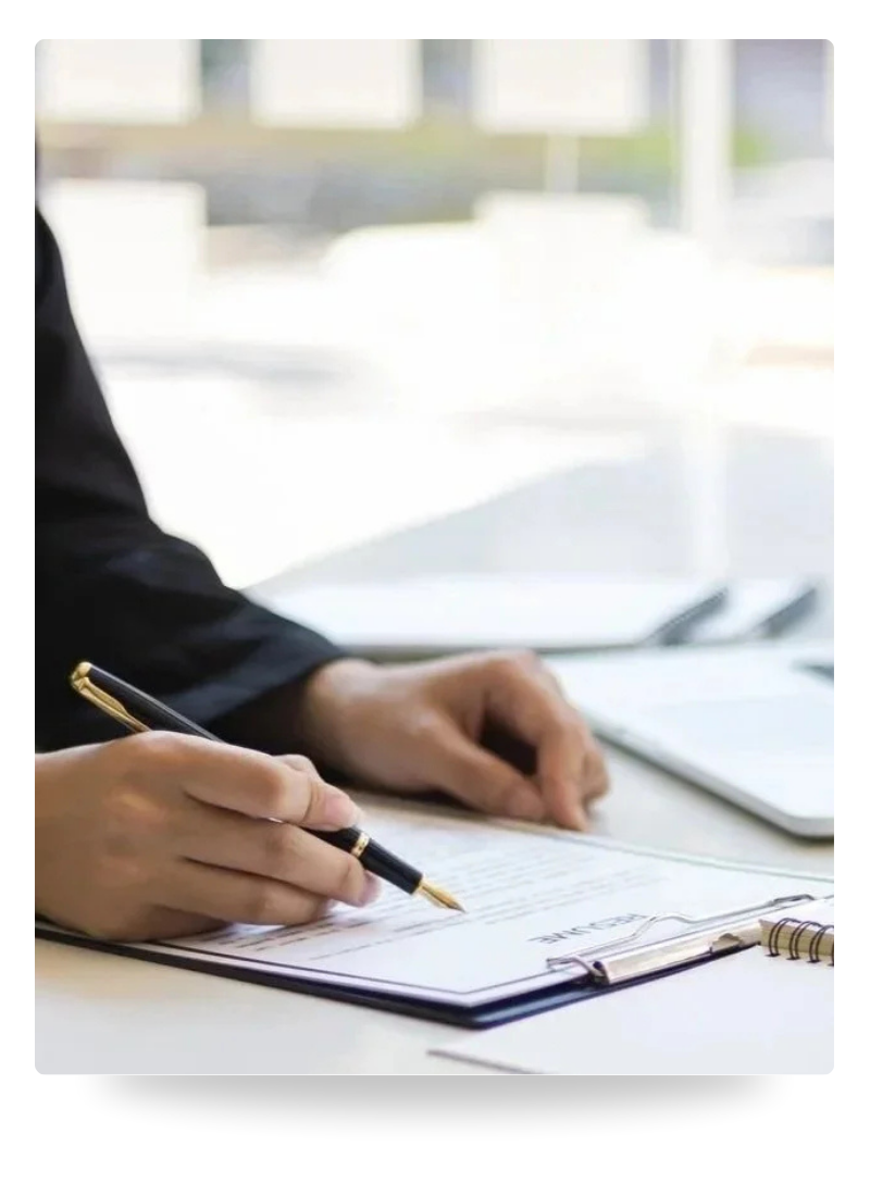 Image of a person signing a contract using a fountain pen. Representing Farrah Chrstos offering mediation as a service.