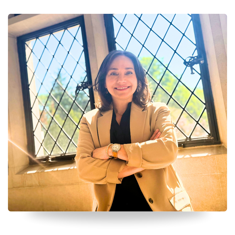 Farrah Christos, LCSW, LISW and licensed therapist, smiling with arms crossed while wearing a beige blazer