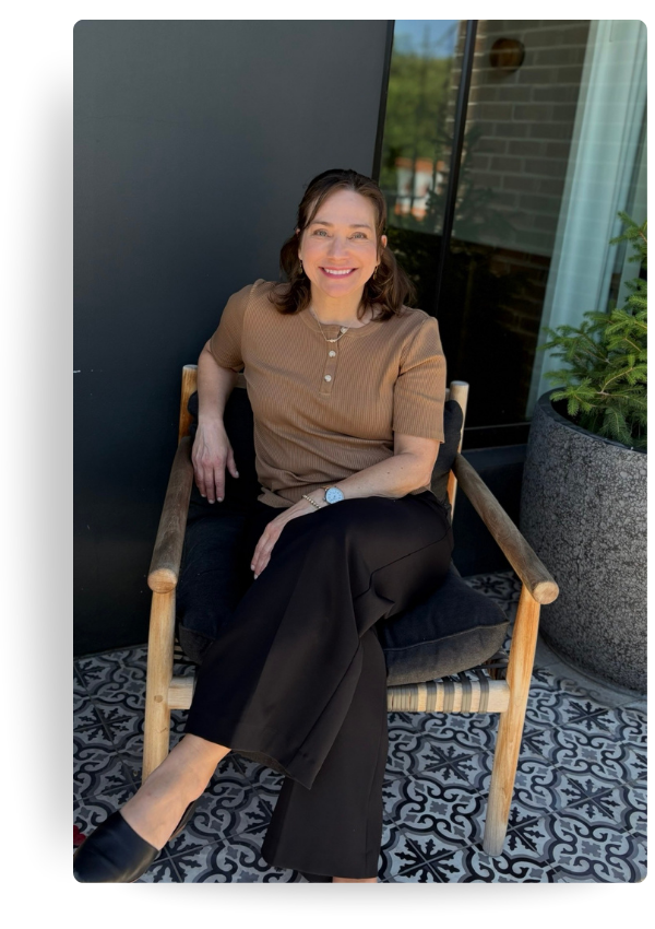 Farrah Christos, LCSW, LISW and licensed therapist, smiling while sitting outside in a tan sweater