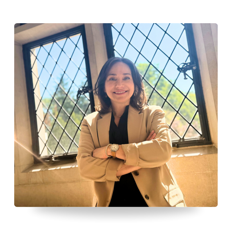 Farrah Chrstos, LCSW, LISW, MSW smiling, and wearing a beige blazer with her arms crossed