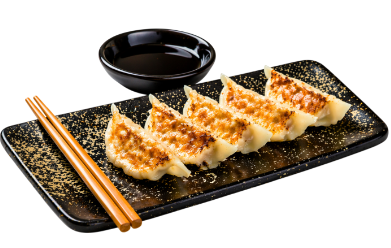 A black rectangular plate with five potstickers, a small black dipping bowl with soy sauce, and wooden chopsticks on the side.