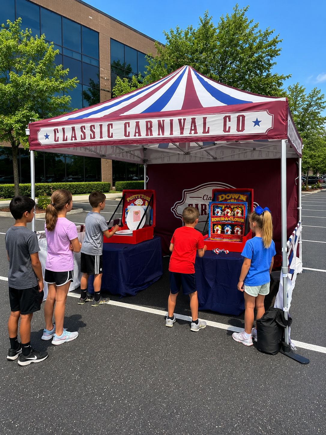 Children lined up at a carnival game booth under a red, white, and blue striped tent labeled 'Classic Carnival Co.' in a parking lot with a modern glass building and trees in the background.