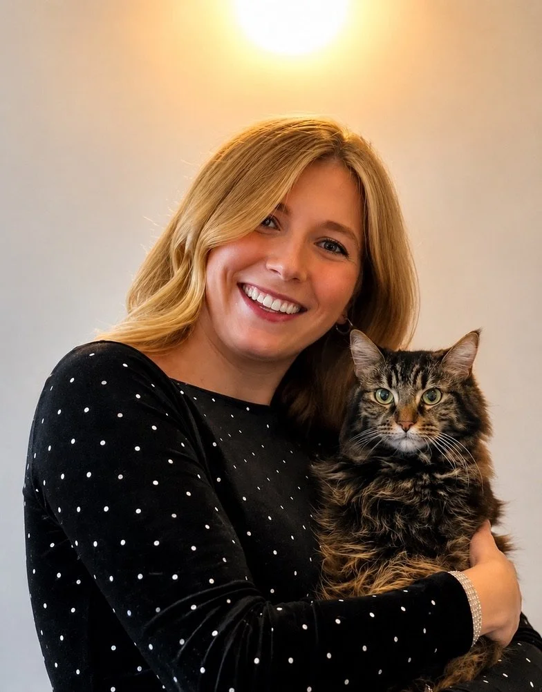 image of Philippa smiling holding her tabby cat, Paddi